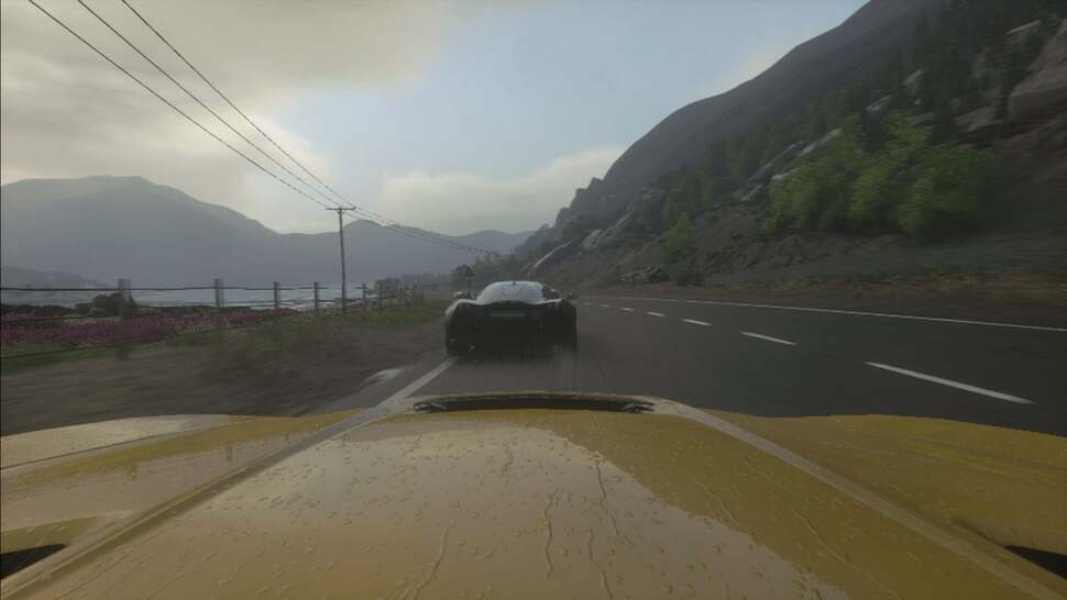 Effects such as raindrops are simulated across a car's bonnet and windscreen, with droplets set to visibly wipe away while in cockpit view.