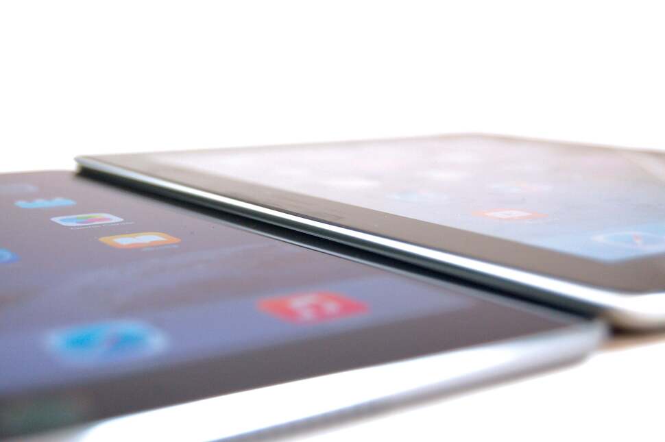 The new iPad Air is so thin it actually tucks in underneath the curved edge of the older unit's casing