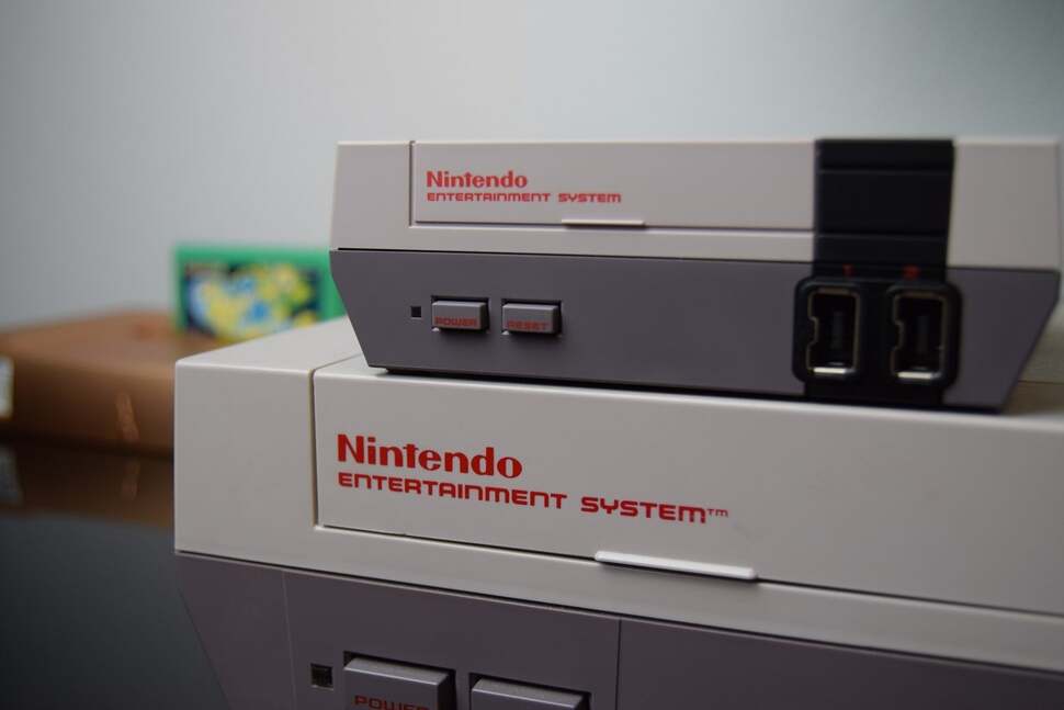 The Mini perched on top of its bigger, older brother - the original Nintendo Entertainment System.