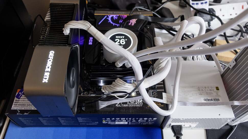 White cables look lovely in a case, but appear tangled in test rig mode. Still, thanks to the RTX 4090 Founders Edition, 360mm NZXT Kraken Elite 360 RGB AiO and NZXT C1200 Gold 1200W PSU, the 285K has all it needs to succeed.