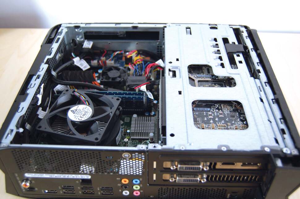 Removing the CPU fan shroud and the optical drive reveals the two sticks of DDR3 RAM, along with the power board in the background, which feeds all the major components like drives and graphics with supplementary juice