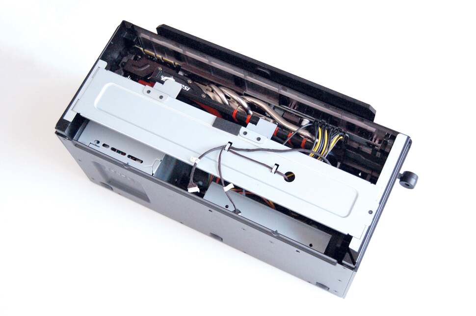 To access the dock's innards, you tip it over onto its side. Removing four screws allows you to pry off the lid, revealing this