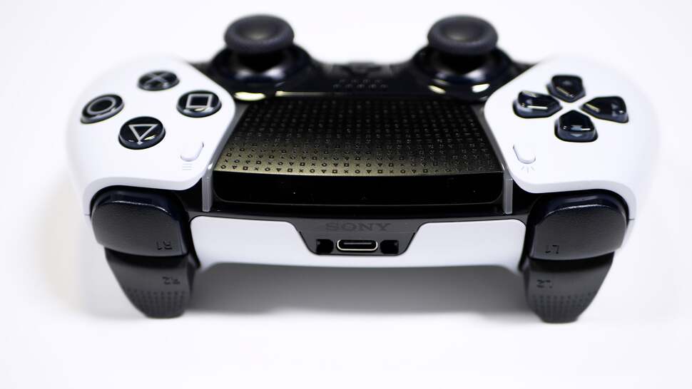 The touchpad sports a subtle design, visible here, and there's extra texture on the triggers. Holes on either side of the USB-C port allow the cable to be securely affixed