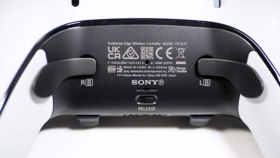 The bottom of the controller - two paddles and the release slider for the thumbsticks on the other side are visible
