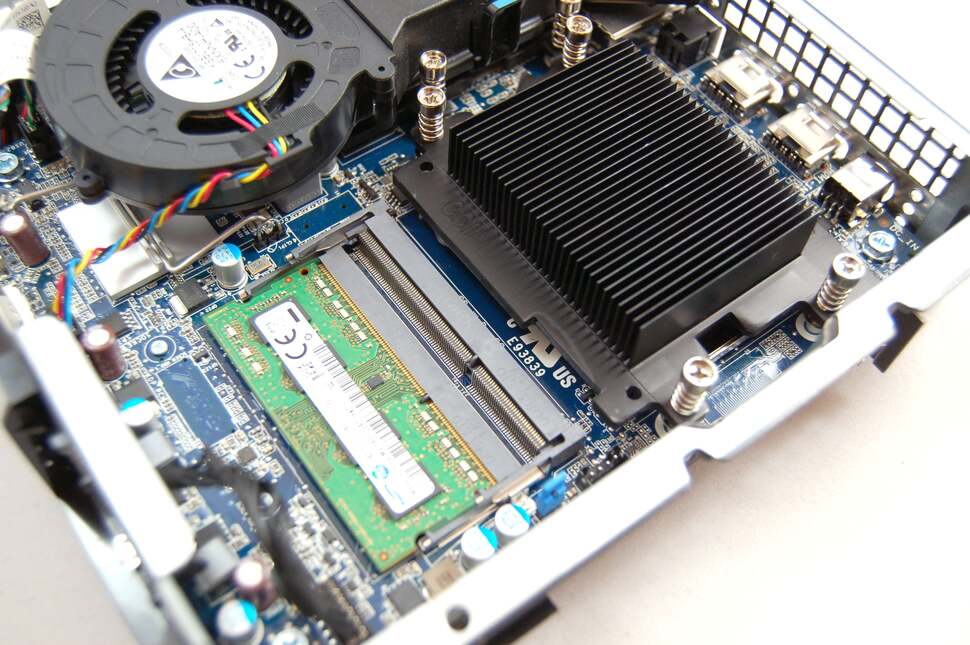Lifting up the CPU cooling assembly shroud allows you to upgrade the RAM. Low voltage SODIMMs are required. You can also see the CPU heat sink here. Remove it and upgrade with any Haswell socket 1150 processor