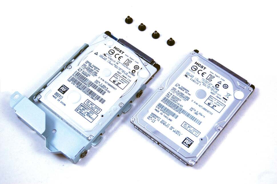 The drive caddy has four small crosshead screws you need to remove before the drive can be replaced - here with a 1TB 7200rpm drive from the same Hitachi family