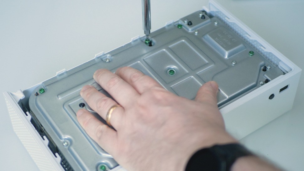 With the bottom exposed, there and black, green and silver Torx 8 screws to remove