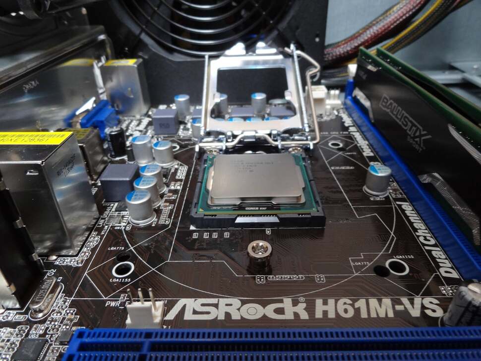 The most crucial point of the process; slotting the 2.8GHz Pentium CPU into the motherboard and clamping it down.