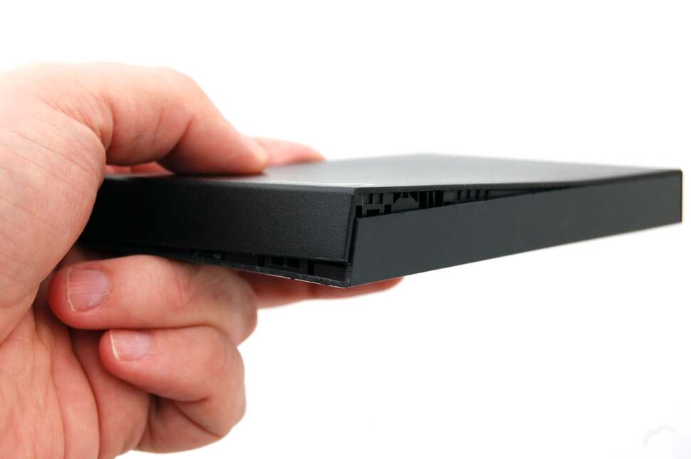 Clips with a friction fit are used to keep both parts of the plastic case together. It may take a bit of muscle, but pulling them apart probably won't break the plastic and it's the best way to get to the drive within