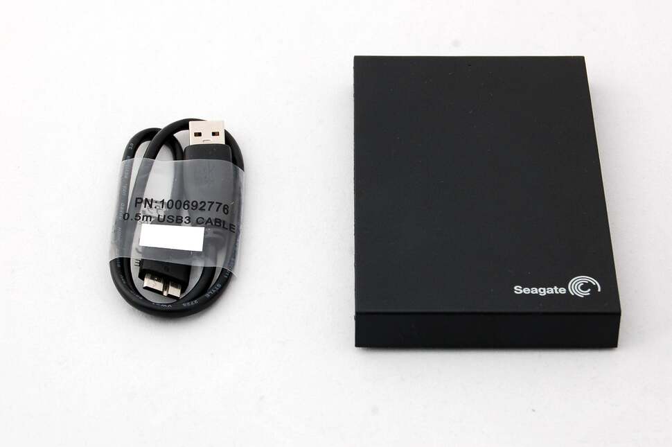 Opening up the package reveals the expansion drive itself along with a USB 3.0 cable. We need to get to the drive inside - use a knife or scalpel to open up the enclosure along its seams