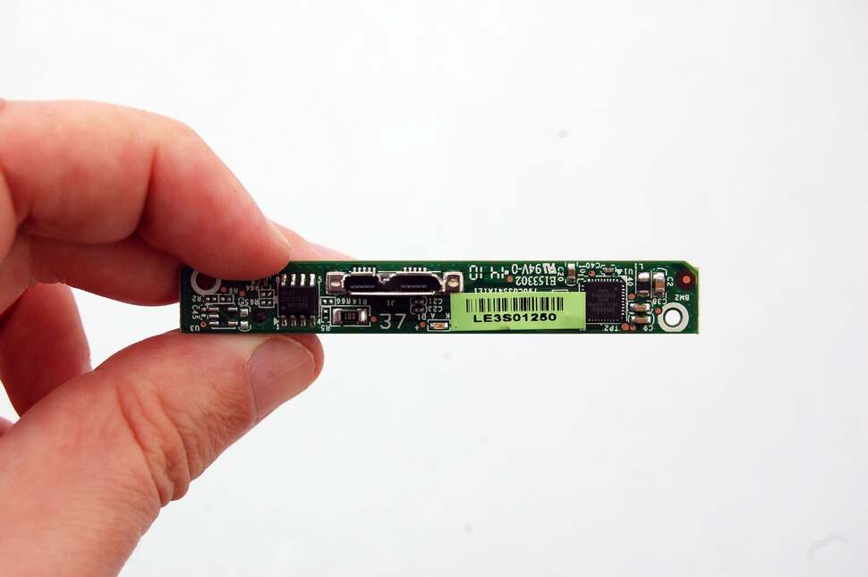 And here's the miniature USB 3.0 to SATA adaptor. Keep that aside along with the metallic paper shroud. You'll need it later for putting another drive back into the enclosure