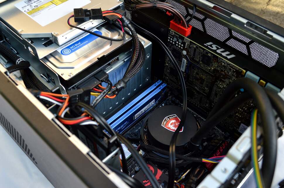 The power supply unit is placed at the front of the unit, with optical and storage drives stacked above. Most of the power cabling routes to its left side, with an extender leading to the mains power socket at the back of the case