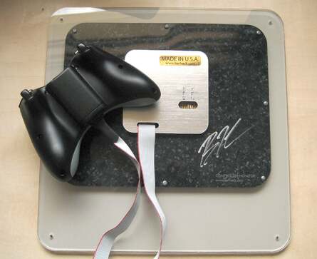 Ben Heck's latency controller monitor in all its glory. The joypad can be disconnected from the board to use as a normal controller. Looking at the back of the board, you can see a bit more of the quality of the workmanship, plus you get Ben's genuine autograph at no extra cost!