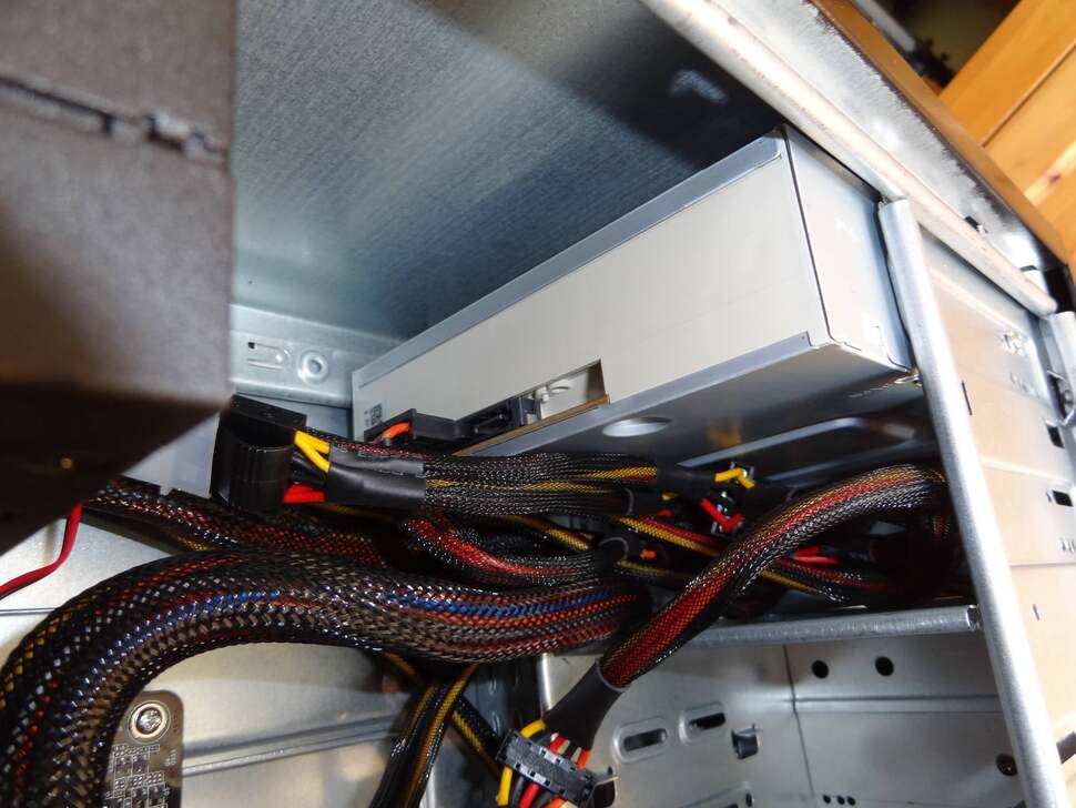 We make sure the DVD-RW drive's Eject button makes contact with the case's front shell before fastening it in. In practise, the drive tray now remains hidden until the silver button on the case is pressed - a nice touch