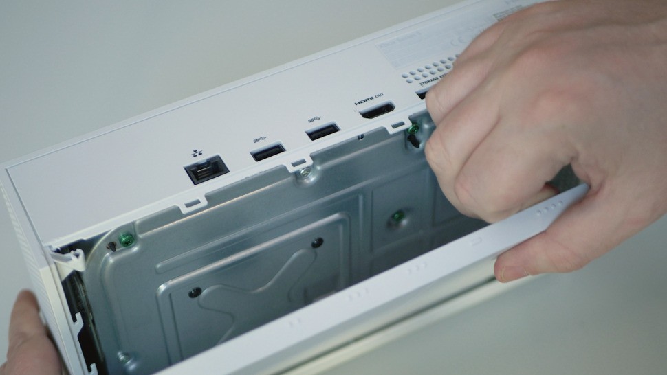 With the screws removed, the bottom tray slides off easily