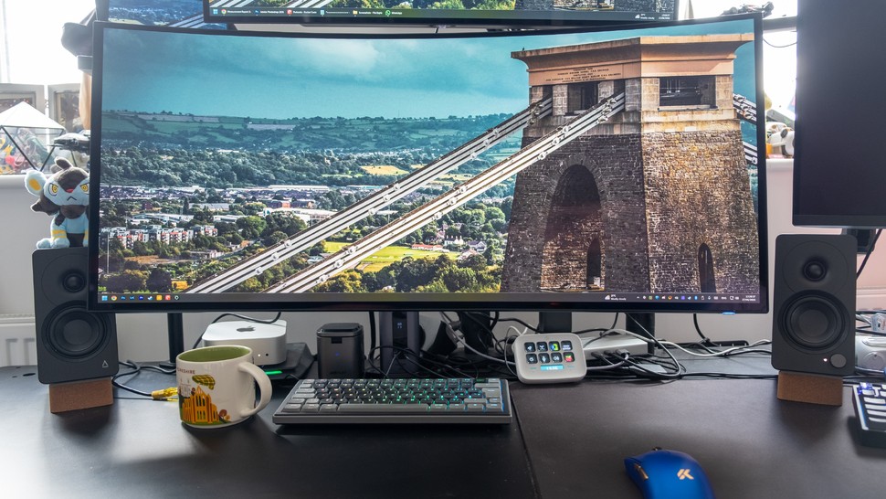 Alienware AW3926QW on a desk with a monitor arm