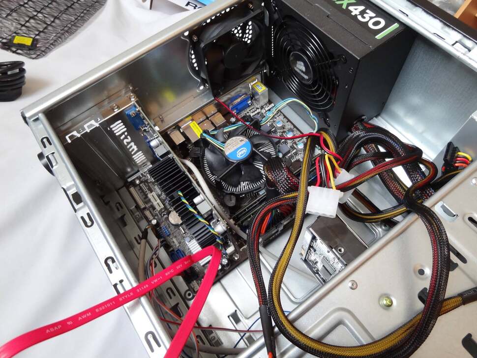 Time to cable up. On the power side, we attach two SATA connectors for the drives, one 6-pin PCIe for the graphics card, and 20+4pin ATX connectors for the motherboard. Many of the connectors for the case's front panel are near the board's bottom edge