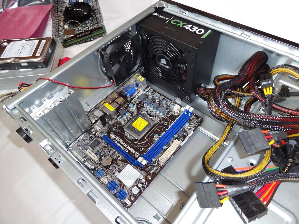 The Corsair power supply slots in at the top - it's not a clean fit, and bending the case's metal supports by a few millimetres is necessary to make it land. This is the only cause for hassle that we notice while building