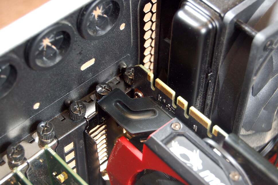 Once the power cables are attached to the new card, don't forget to screw in your new GPU, fastening it to the chassis with the two screws you removed earlier