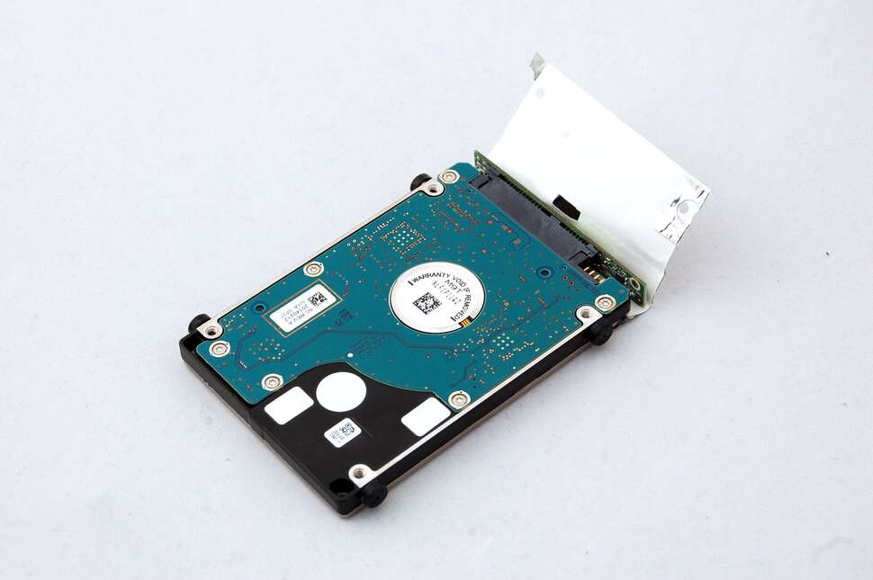 The silver paper at the end appears to be an insulating shroud for the USB to SATA adaptor stuck onto the end of the drive. It can be peeled away easily enough